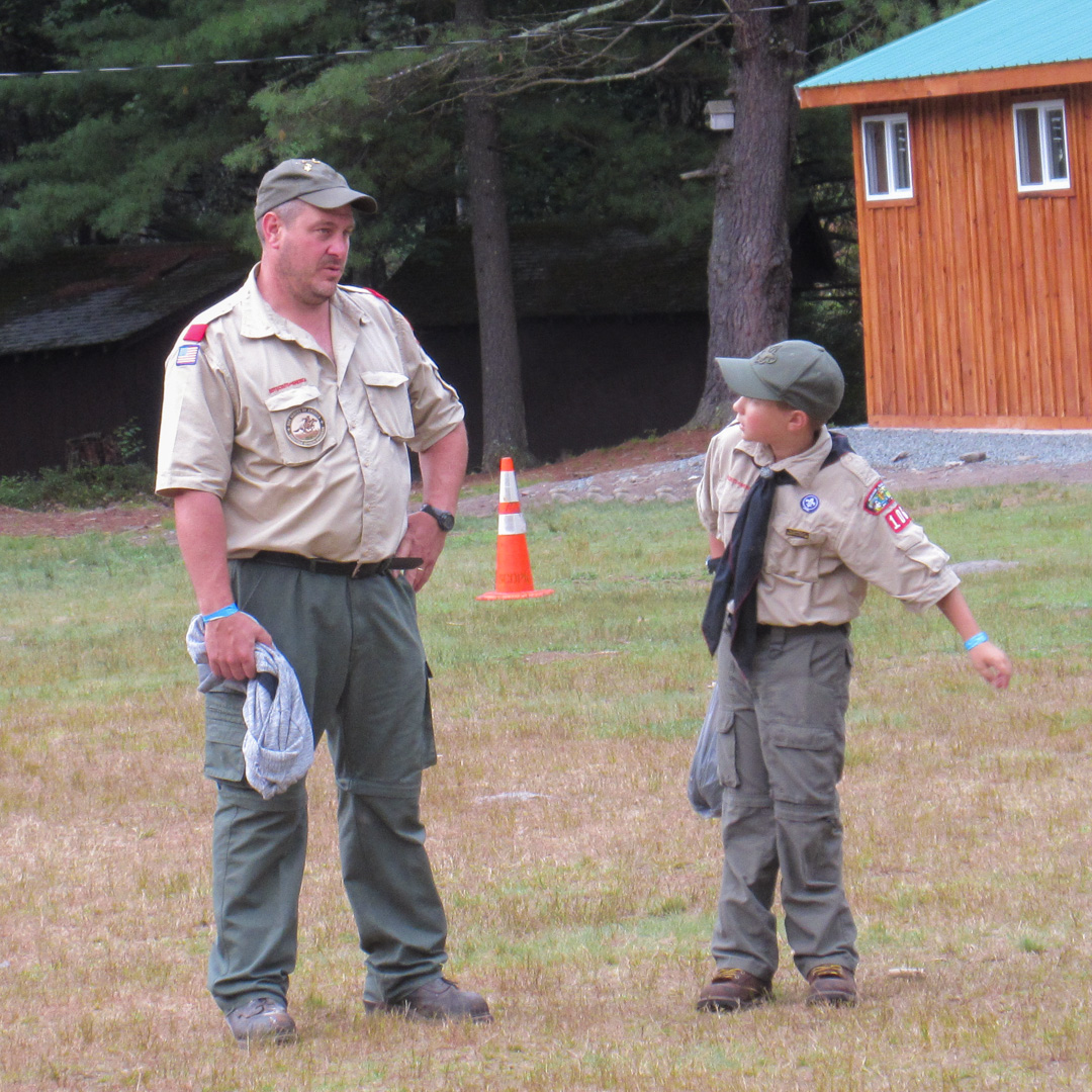 A scout and scoutmaster at camp