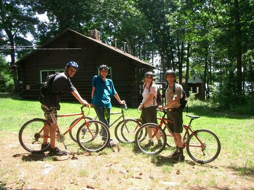 Scouts and leaders posing during a bike trip at summer camp