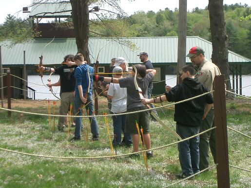 Scouts practicing archery at a camporee